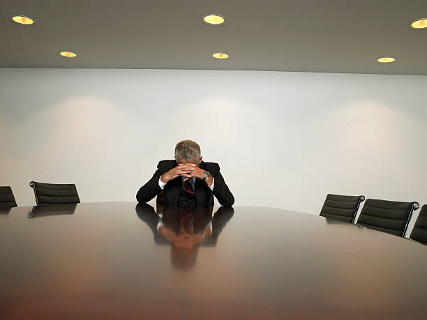 istock Stressed Out Businessman Sitting At Table In Conference Room 529690969