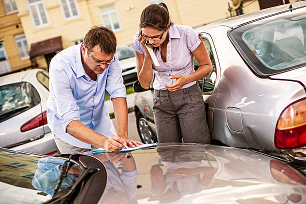 Drivers Fill Out an Accident Report Drivers fill out an accident statement report after having a parking lot accident. traffic accident photos stock pictures, royalty-free photos & images