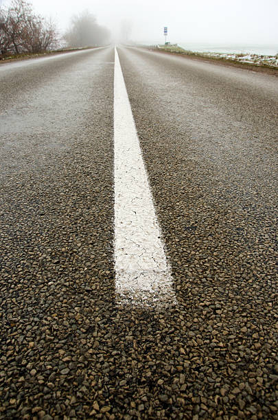 istock empty rural asphalt road in autumn mist 529691581