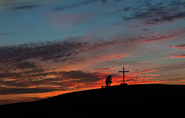 istock Colorful Sunset Praying Man 529691799
