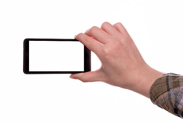 Woman making pictures with mobile smart phone, hand holding device isolated on white background with blank white screen as copy space