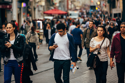Istanbul, Turkey - October 23, 2014: Crowded Istiklal street in Istanbul on rush hour. Hurrying people walk on istiklal caddesi