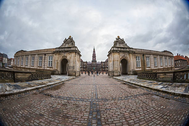 16 April 2018, Copenhagen, Denmark.\nHistoric Royal Amalienborg Palace with Elegant Architecture and Danish Flag Displayed