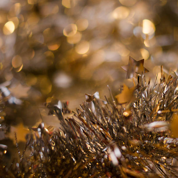istock Tinsel on a golden defocused lights background 529694611