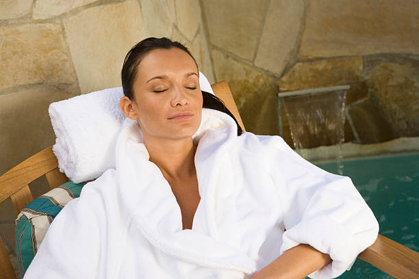 istock woman relaxing by pool 529695871