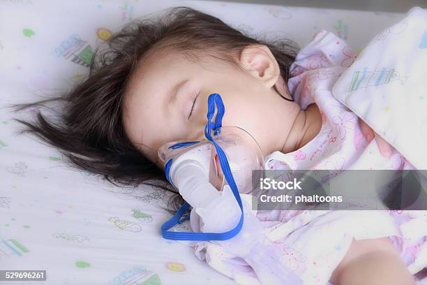 Baby Girl With A Mask For Inhaler In Hospital Stock Photo - Download Image Now - Baby - Human Age, Inhaling, Mask - Disguise