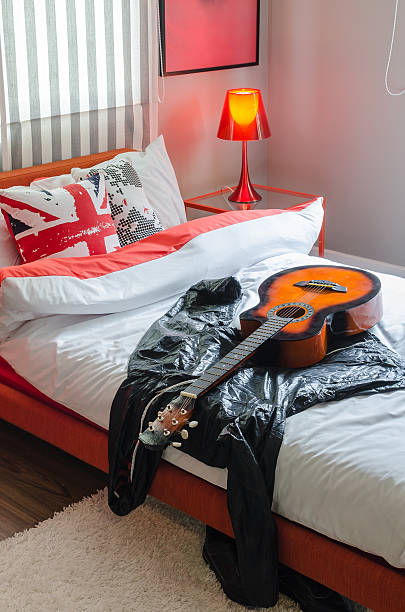 istock modern bedroom with guitar and jacket on white bed 529696777
