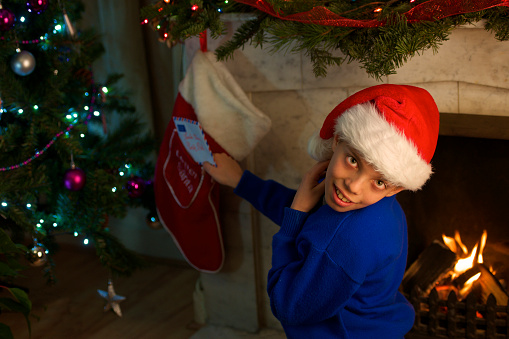 front to the fireplace young kid send Santa letter
