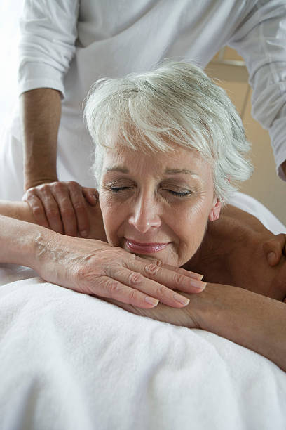 istock Senior woman having massage 529723409