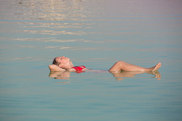 istock Beautiful girl floating at the Dead sea 529724113