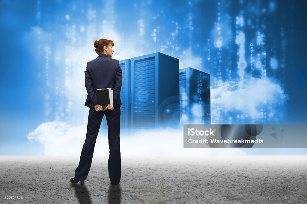 Composite image of businesswoman looking Businesswoman looking against cloud computing graphic with server 30-34 Years Stock Photo