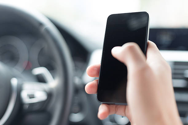 istock asian young businessman using smartphone in car 529724793