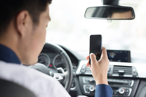 istock asian young businessman using smartphone in car 529724877