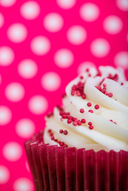 istock close view on cup cake over colorful pink dotka background 529725189