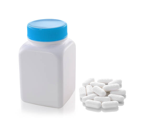 istock pills out of bottle on white background 529730297