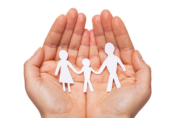 istock Paper chain family protected in cupped hands 529742499