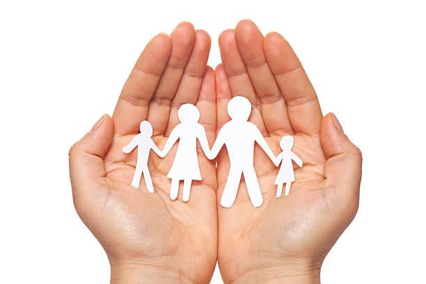 istock Paper chain family protected in cupped hands 529742503