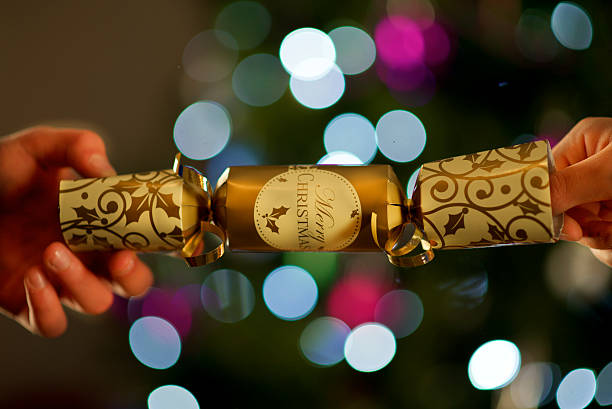 Christmas Cracker and bokeh two boys hand ,detail ,of merry christmas cracker and bokeh christmas cracker stock pictures, royalty-free photos & images