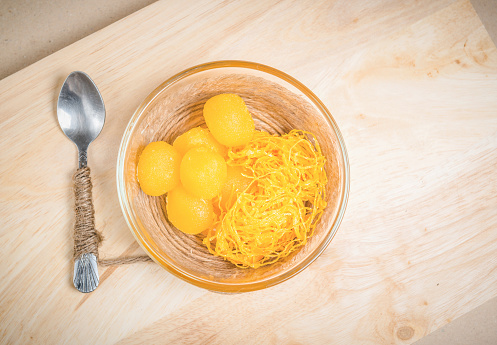 Thai dessert golden threads and egg yoke fudge balls cooked in syrup.