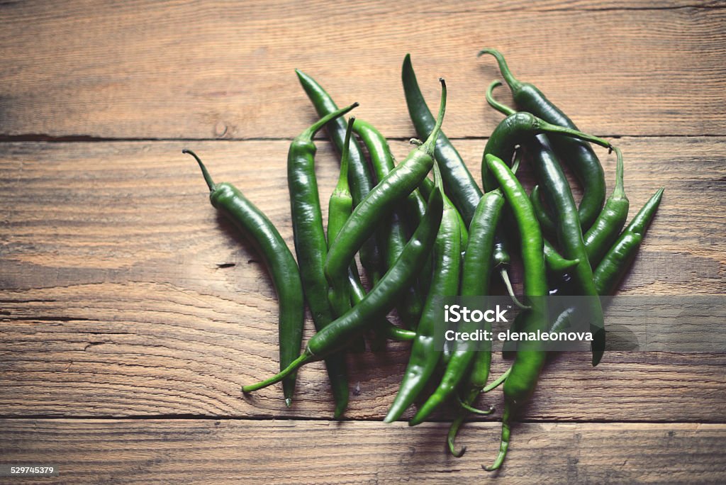 green chili peppers green chili peppers on a wooden background Green Chili Pepper Stock Photo