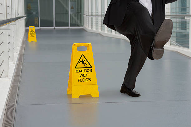 istock Man in suit slipping on wet floor 529747397