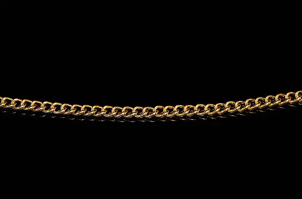 Photo of gold chain isolated on a black background
