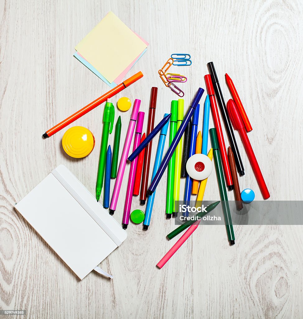 Office tools assortment on white table Multicolored office tools assortment on white table Book Stock Photo