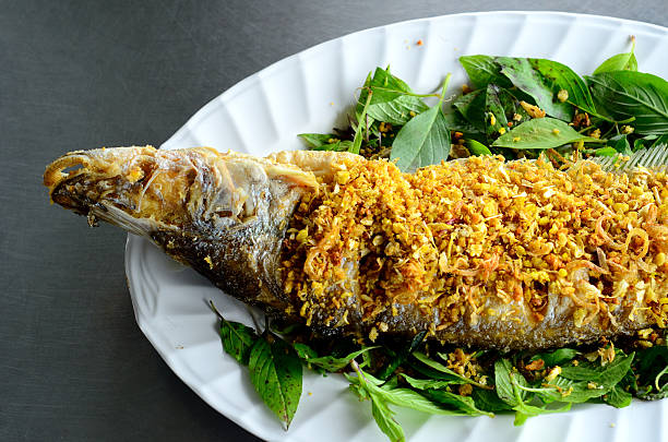 Sheatfish (Micronema apogon) fried fish Sheatfish (Micronema apogon) on table at Thai native market sheatfish stock pictures, royalty-free photos & images