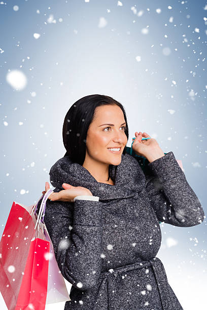 istock Smiling woman holding shopping bag 529767273