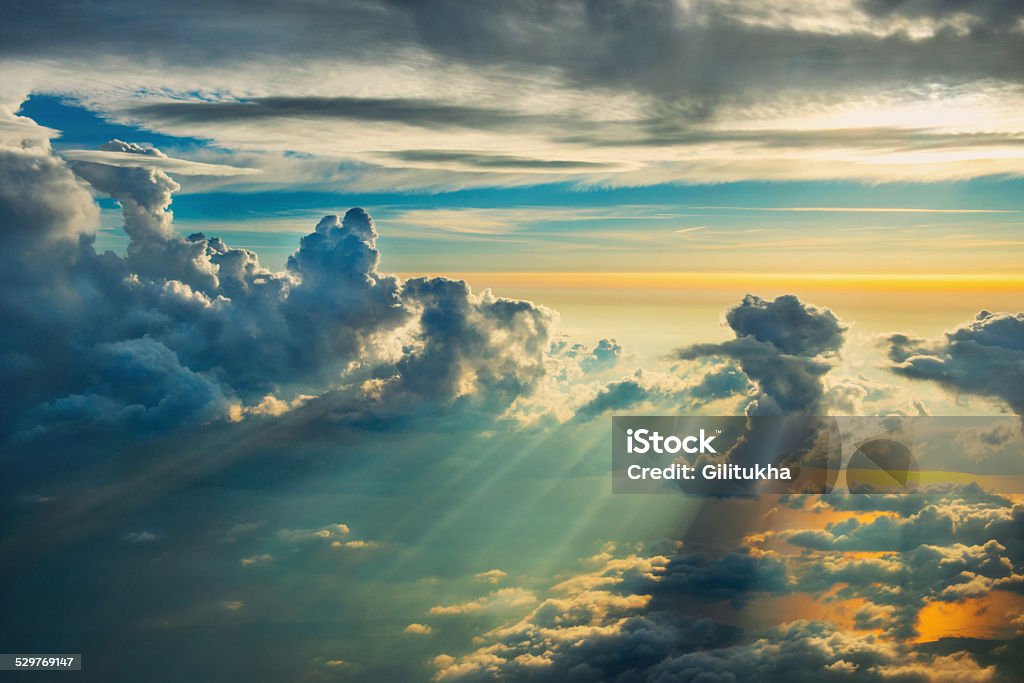 Above the clouds on sunset View from airplane on gold clouds Above Stock Photo