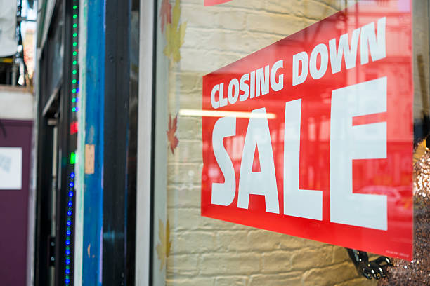 Closing down sale Detail of a closing down sale sign with on shop window closing down sale stock pictures, royalty-free photos & images