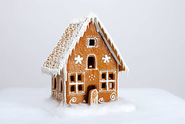 The hand-made eatable gingerbread house and snow decoration stock photo