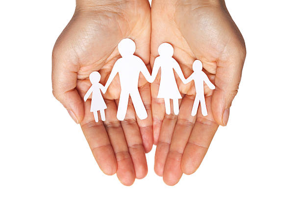 istock Paper chain family protected in cupped hands 529770061