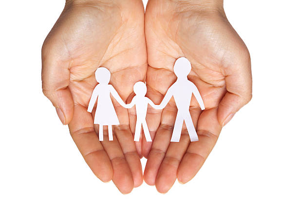 istock Paper chain family protected in cupped hands 529770065