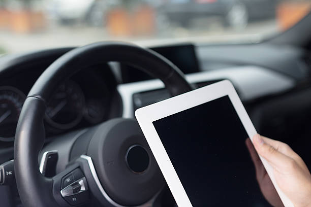 istock asian young businessman using smart tablet in car 529771525
