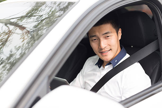 istock asian young businessman using smart tablet in car 529771559