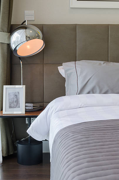 istock grey pillow on bed with lamp 529774141