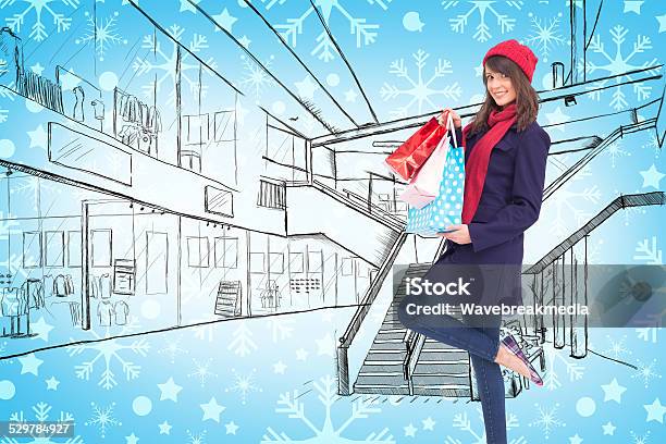 Happy Brunette In Winter Clothes Holding Shopping Bags Stock Photo - Download Image Now