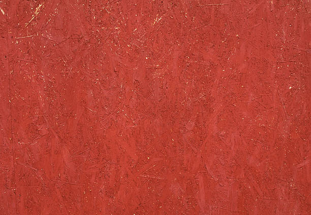 istock Texture of wall from chipboard, painted in red 529785245