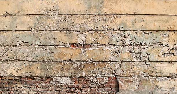 istock Texture of old  wall covered with yellow stucco 529785545
