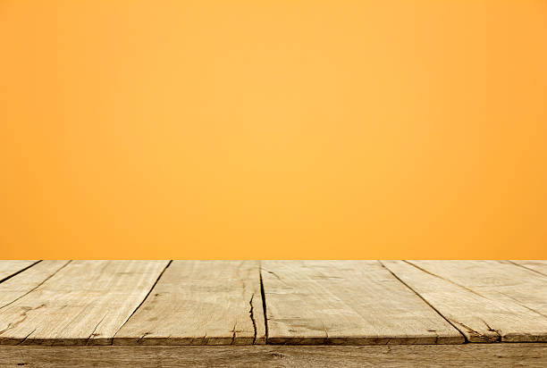 istock wooden and orange wall blur background 529789277