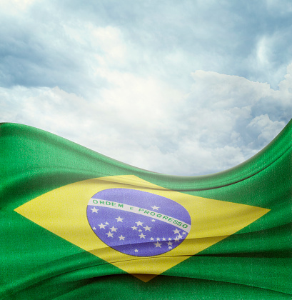 Brazilian flag in front of bright sky