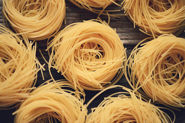 istock pasta closeup on wooden background 529789481