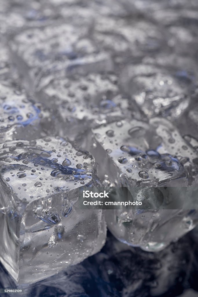 Rows of Ice Cubes Diagonal Rows of Ice Cubes with water droplets against a blue background Blue Stock Photo