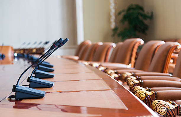 conference table conference table with group of microphones before conference. shareholders meeting stock pictures, royalty-free photos & images