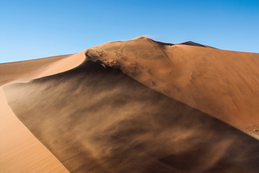 Sand dune on a windy day at Sossusvlei, Namibia.