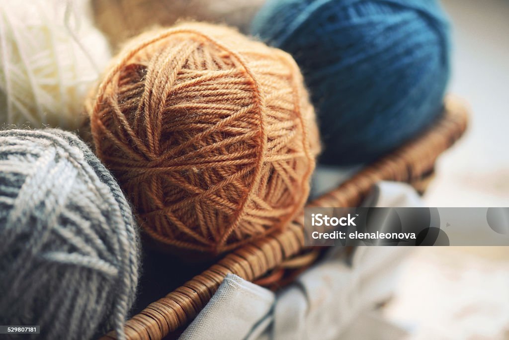 balls of wool balls of wool in a basket on a wooden background Ball Of Wool Stock Photo