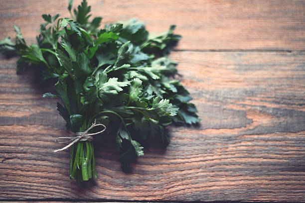 istock bunch of parsley on a wooden background 529807209