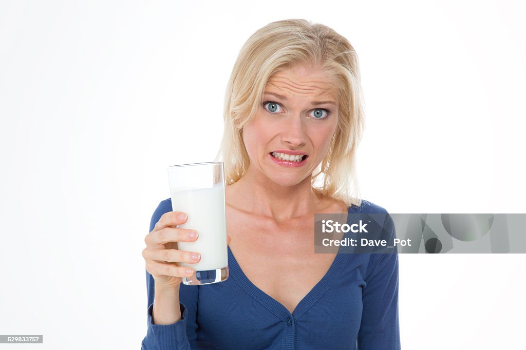 beautiful girl makes grimace on closeup pretty woman with bellyache because sheâs intolerance to lactose Lactose Fermentation Stock Photo