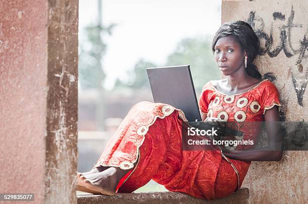 Working On Using Computer Symbol African Ethnicity Woman Learning Typing Stock Photo - Download Image Now